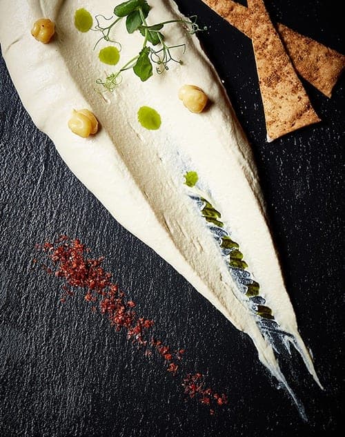 Assiette dressée sur ardoise noire au restaurant Basilico à Luxembourg